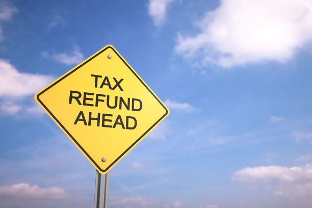 Tax Refund Ahead road sign with a beautiful blue sky in the background. Refund Management Services are the tax refund experts.